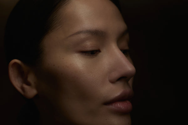 Close-up of a person's face with a dark background