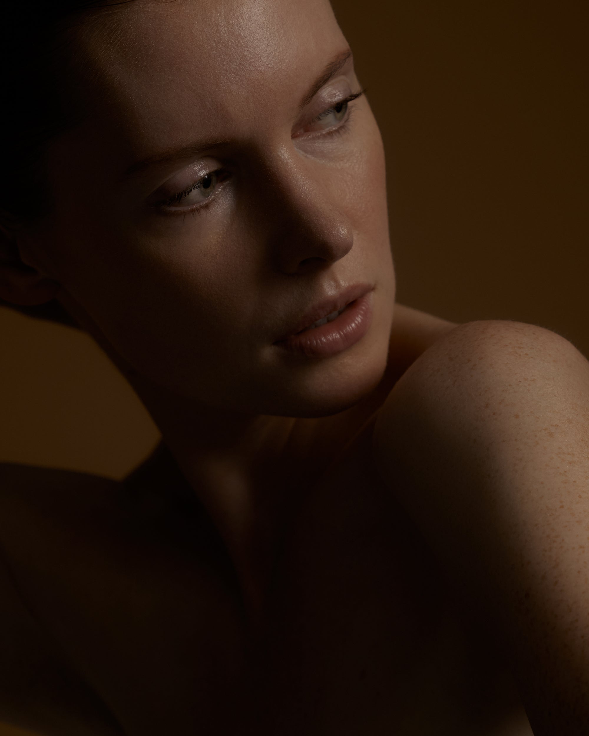 woman with a dark brown background