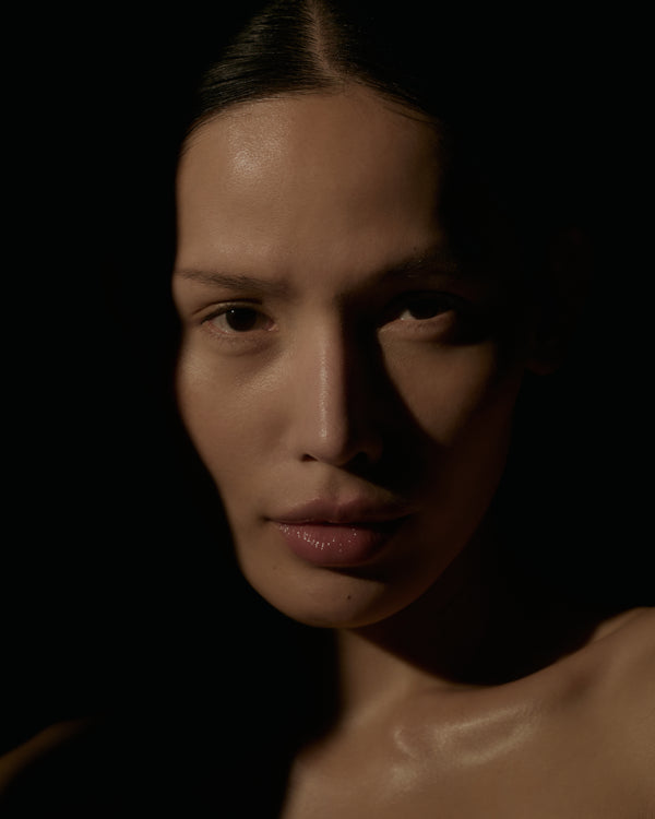 Close-up of a person with a dark background