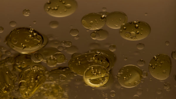 Close-up of oil and water bubbles on a brown background
