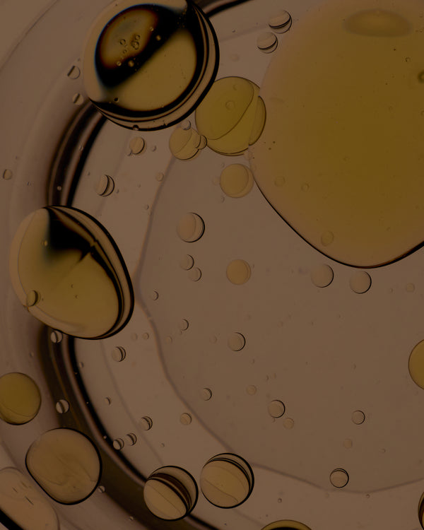 Close-up of oil and water droplets on a white background