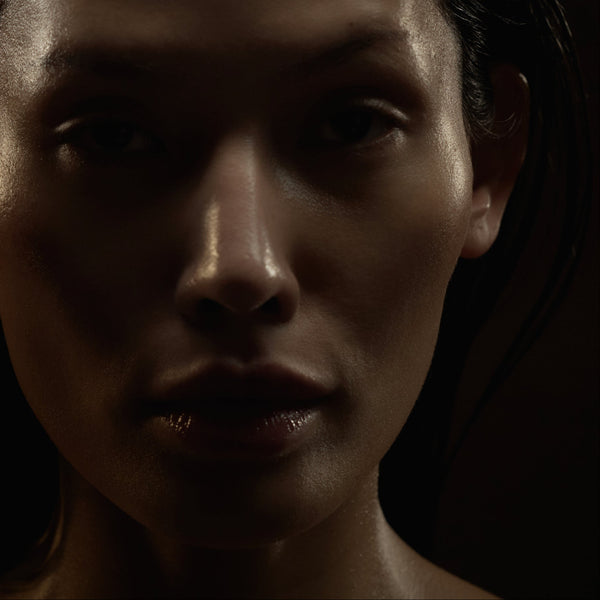 Close-up of a person's face with a dark background
