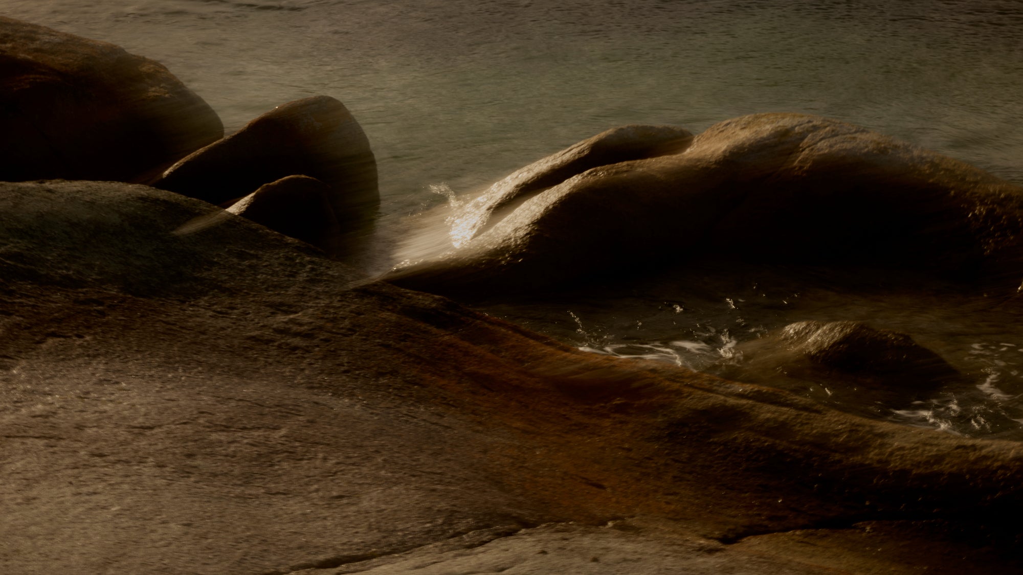 Rocks with water flowing over them in a natural setting